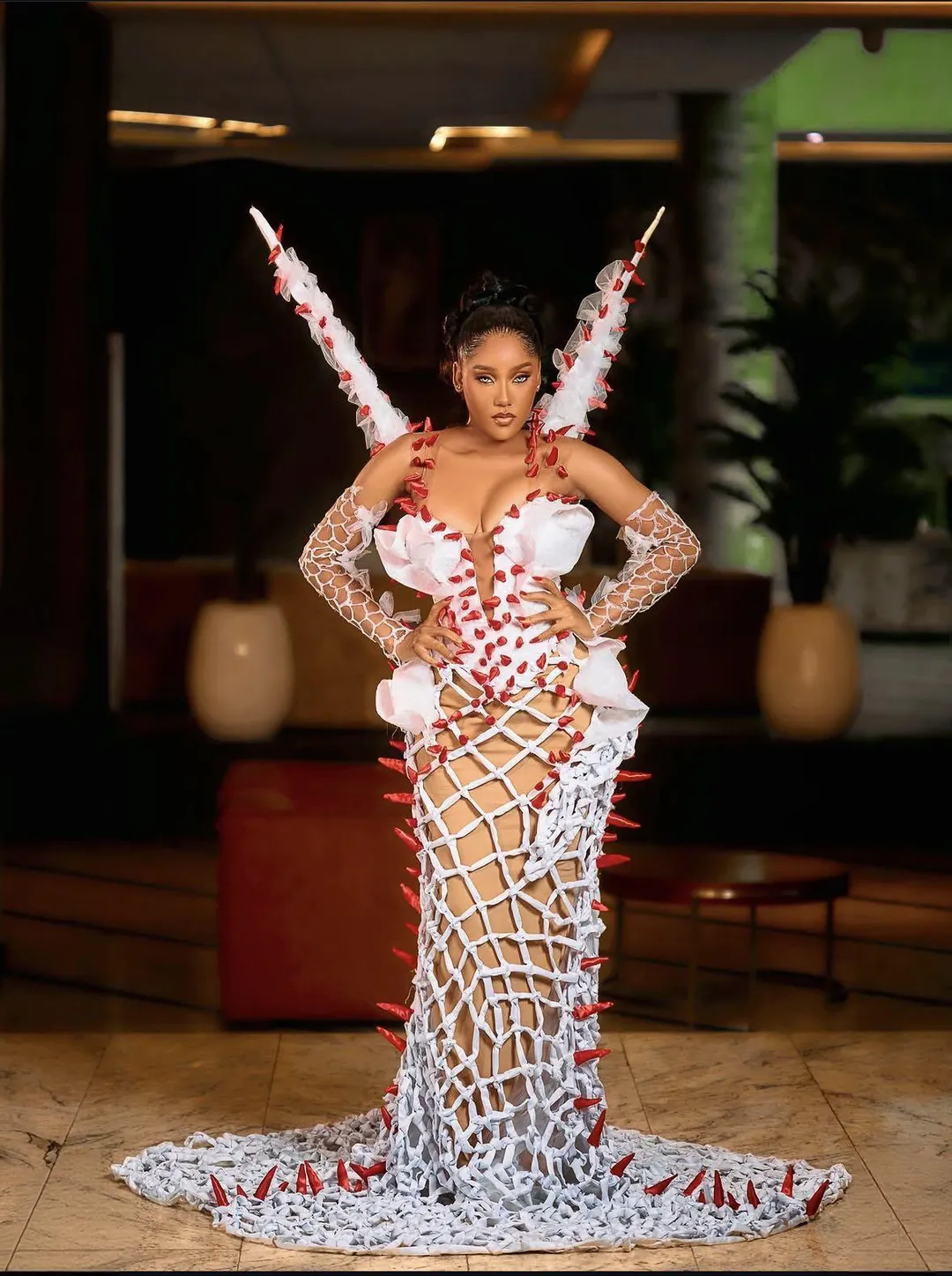 Full look: sculptural white couture gown with red spikes
