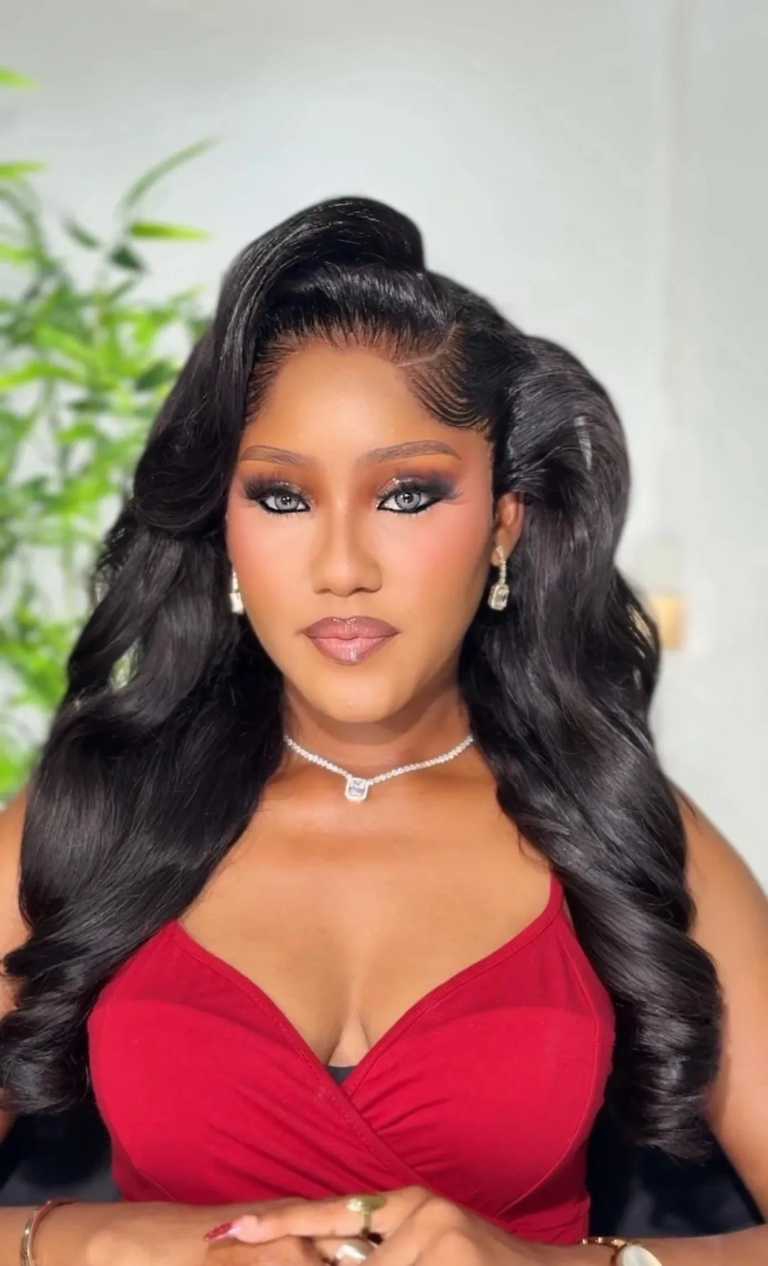 Red top, bronze-gold eyes and long waves, facing forward