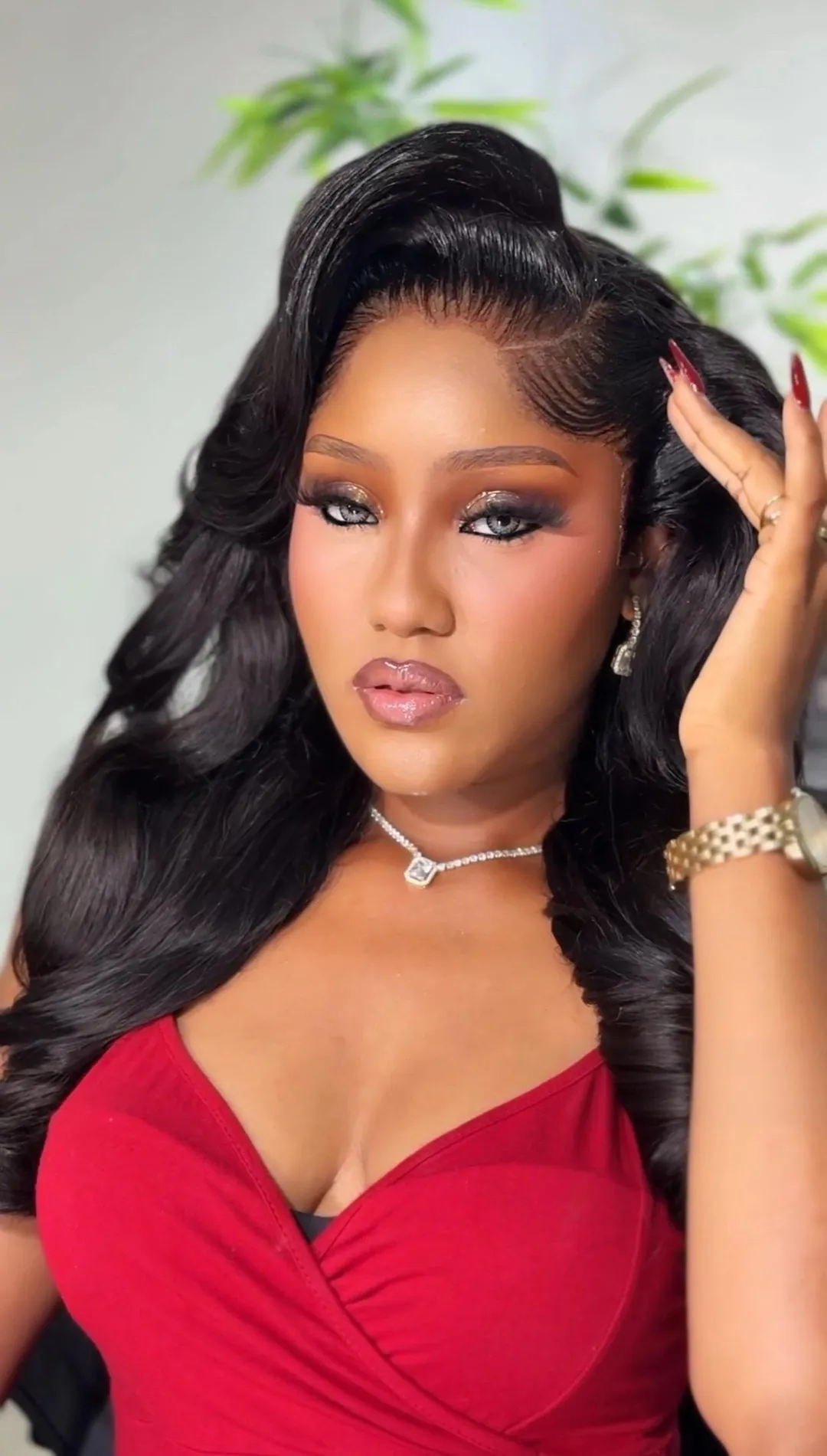 Beauty close-up in a red top, long glossy waves