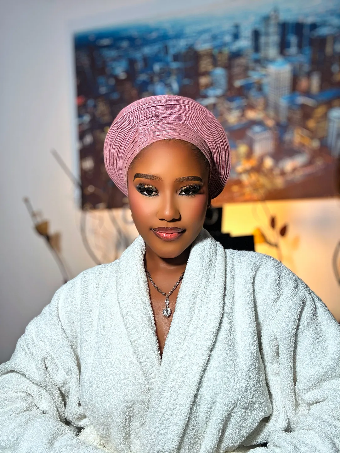 Blush gele and white robe, a soft smile