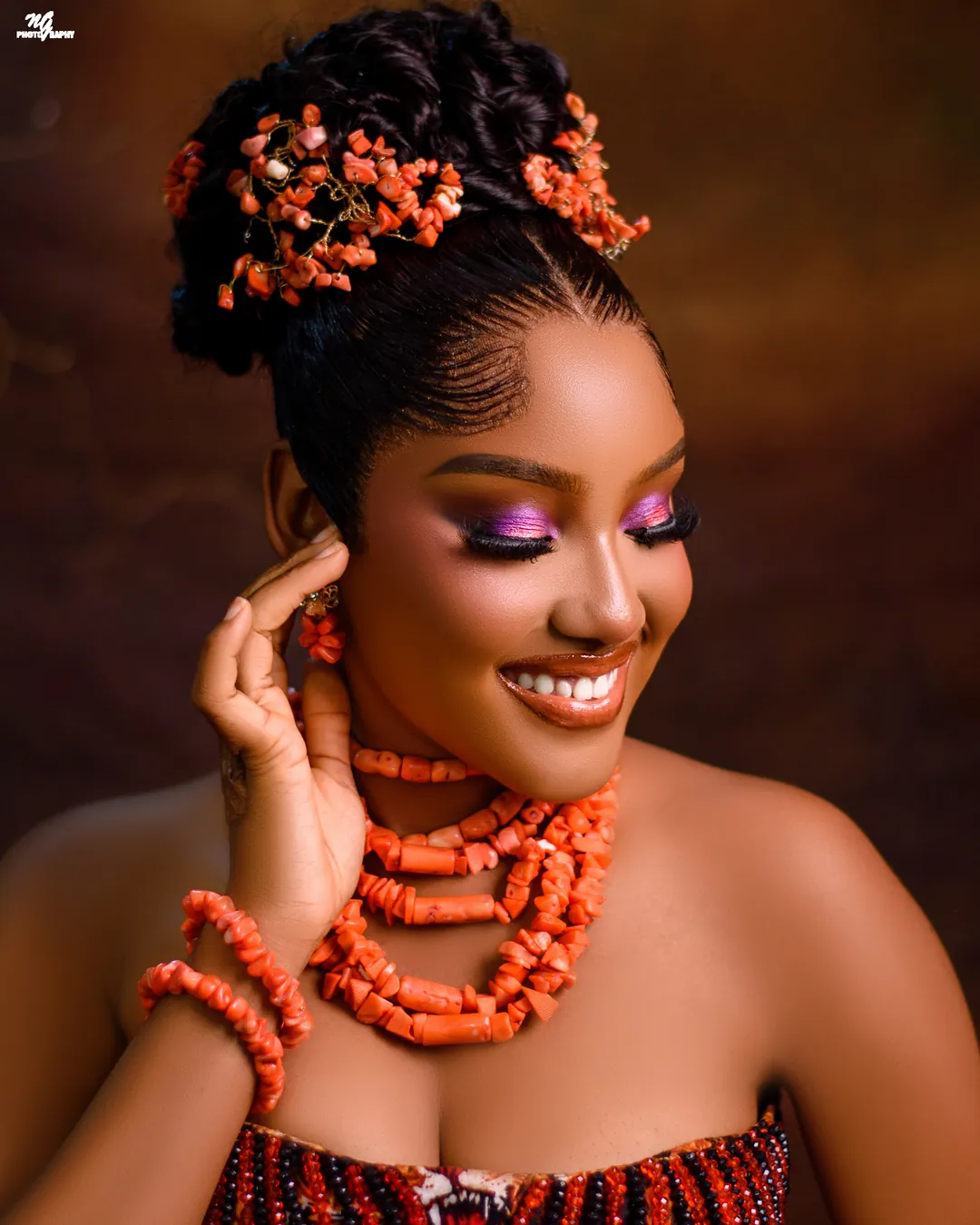 Smiling colour portrait in coral beads and a coral hairpiece
