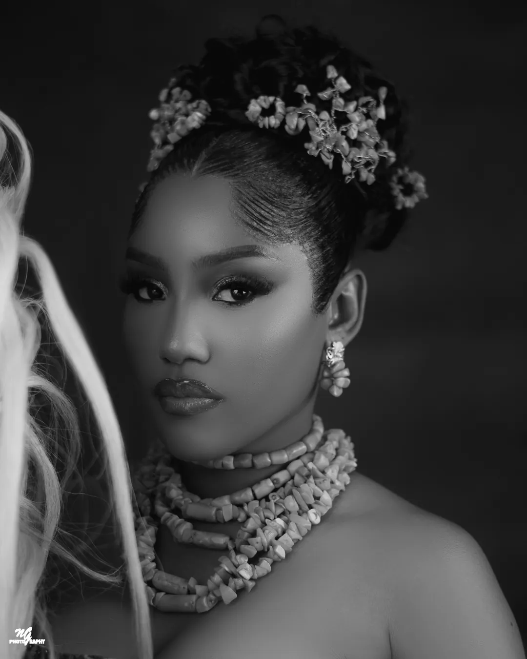 Black-and-white portrait in coral jewellery and drop earrings
